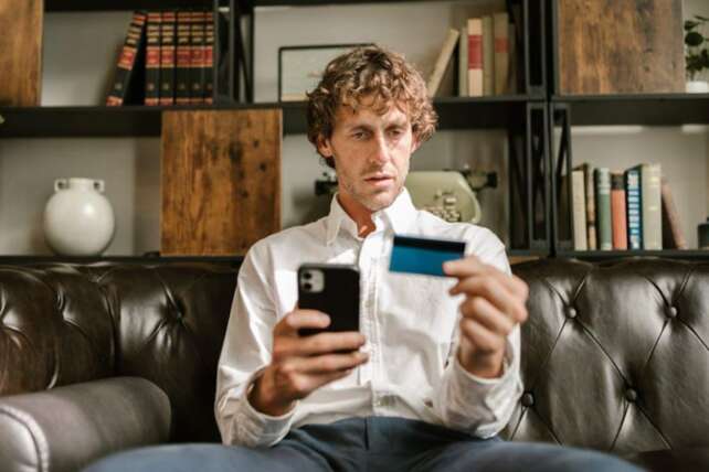 man checking credit card balance - 50/30/20 Rule