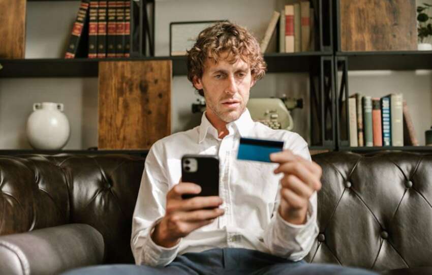 man checking credit card balance - 50/30/20 Rule