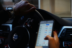 A man using his phone looking at crypto data fluctuations on his phone